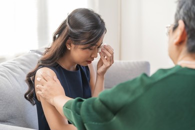 psychology, depression. sad asian young woman cry about break up or divorce, consulting with psychologist ,psychiatrist while patient counseling mental with doctor at clinic. encouraging, therapy.