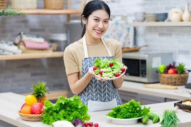 image of asian woman preparing salad in the kitchen