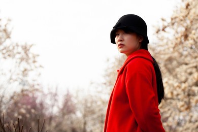 beautiful asian red woman in the woods