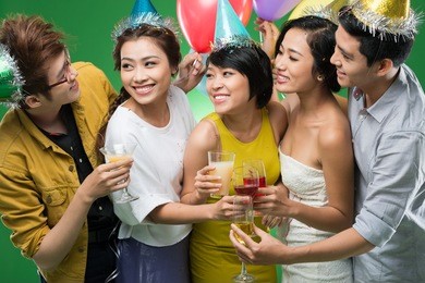 young vietnamese people clinking at the party
