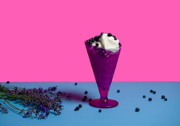dessert of ice cream in a purple vase with fresh blueberries and lavender sprigs. dessert for a hot party. isolated object. copy space, advertising - suitable for any field of activity. vary peri