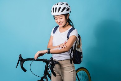 beautiful asian women she is cycling in the sun. she applied the cream and lotion.