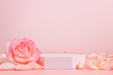 empty podium with pink rose flowers on pink background to display products, gift or cosmetics. podium with copy space for design or advertising
