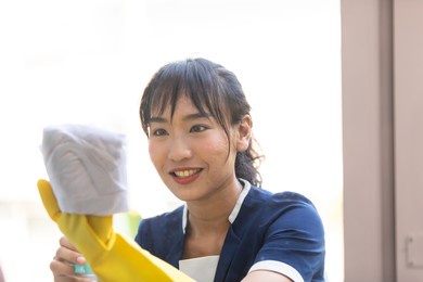 housekeeper or maid cleaning hotel room. asian woman worker working in hotel and resort.
