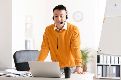 asian teacher conducting lesson online in classroom