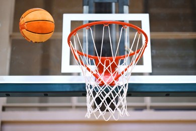selective focus of modern indoor basketball hoop inside gym.