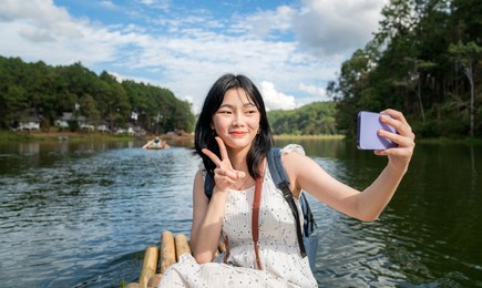asian traveller girl selfie on the bamboo boat at pangung, pang ung, mae hong son, thailand