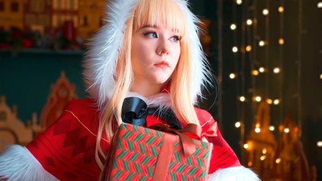 little red riding hood girl holding a gift in a red box. beautiful eyes. smiling