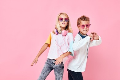 portrait of a girl and a boy wearing headphones posing casual kids fashion