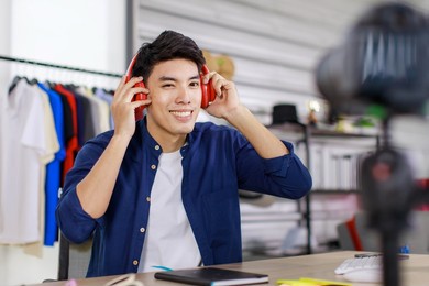 adult asian seller man look intend holding looking at camera to present product via live online for shopping online with e-commerce sell.