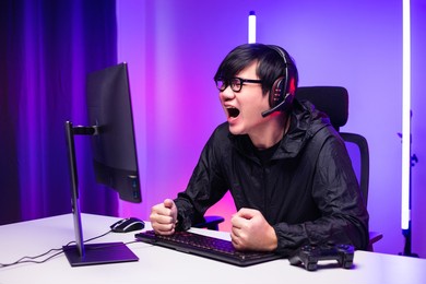 angry asian gamer man playing computer pc. he lose in the game. missed the chance to become a champion in tournament. unhappy upset man streaming video game online and lost.