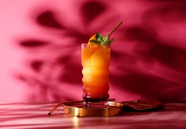 glass of tasty tequila sunrise cocktail on color background