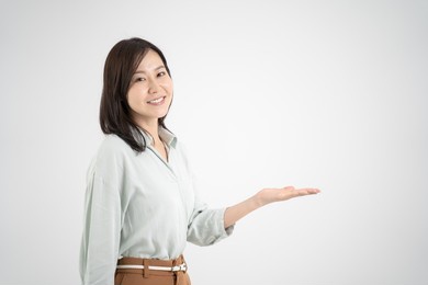 female explaining service with a smile, white studio shot background