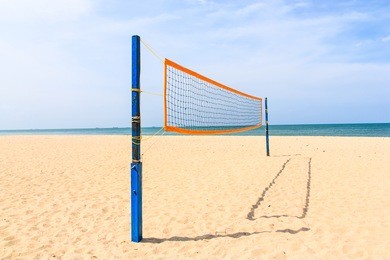volleyball net on the tropical beach with blue sky
