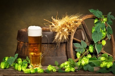 glass of beer with raw material for beer production