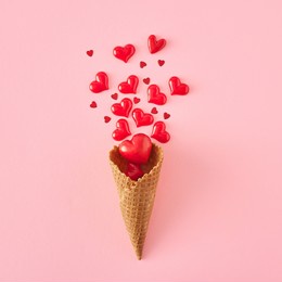 creative layout made of red hearts and ice cream cone on pink background. mother's day or valentines idea, flat lay, top view.