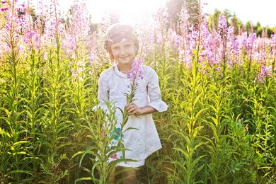 girl playing in a field of flowers in russia