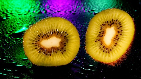 
kiwi on a wet surface in the dark neon lights, abstraction, selective focus					