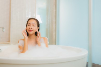 portrait beautiful young asian woman relax smile in bathtub at bathroom interior