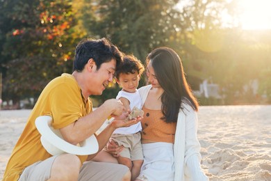 cheerful asian family travel at the beach.cute asian boy playing with parents.