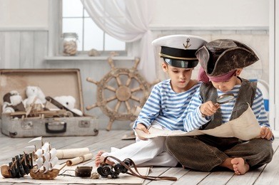 two boys, a pirate captain, read travel map in her room