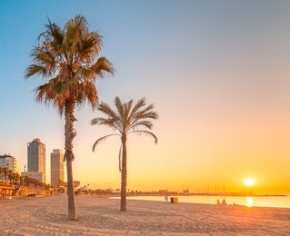 barceloneta beach in barcelona with colorful sky at sunrise
