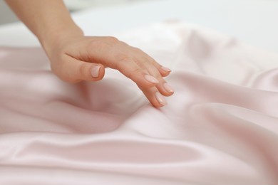 woman touching smooth silky fabric, closeup view