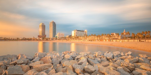 barceloneta beach in barcelona with colorful sky at sunrise