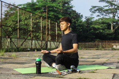 relaxed man doing exercise and meditation yoga on nature outdoor