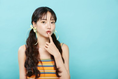 fresh portrait of young asian woman on blue background