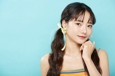 fresh portrait of young asian woman on blue background
