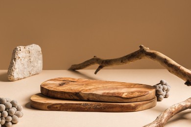 wood pieces podium with stones and branches decorations. background for perfume, jewellery and cosmetic products. front view.
