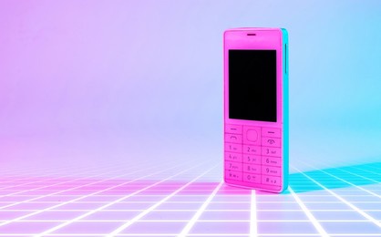retro cell phone vintage concept. white old mobile telephone in neon pink blue light. retro wave. pop art. minimal idea concept