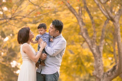 asian young family having fun outdoors in autumn 