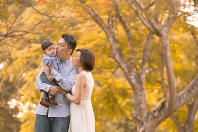 asian young family having fun outdoors in autumn 
