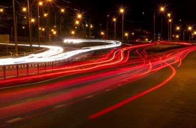 moving car with blurred traffic light through roads and highways in twilight city. night cityscape.


