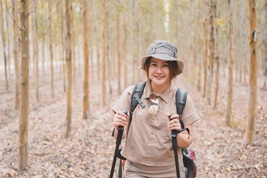 asian woman hiking trail and trekking in the forest alone. travel and outdoor activity. relax and recreation in autumn holiday.