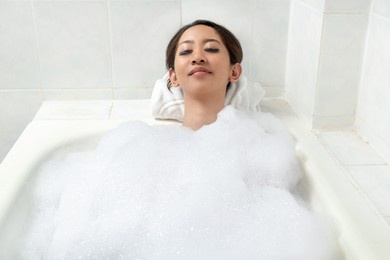 asian woman relaxing on the bathtub