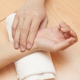 a chinese medical doctor takes the pulse of a patient 