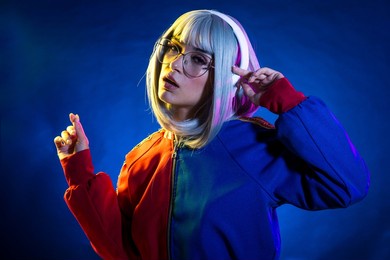 young woman with grey hair dancing and celebrate. colored gel portraits