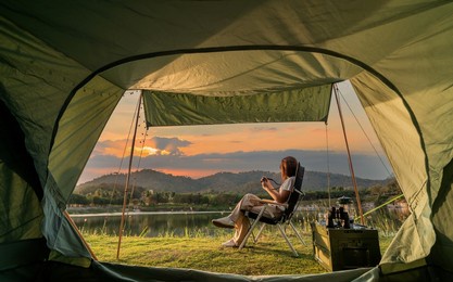 asian woman travel and camping alone at natural park in thailand. recreation and journey outdoor activity lifestyle.