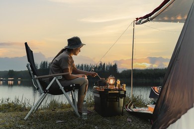 asian woman travel and camping alone at natural park in thailand. recreation and journey outdoor activity lifestyle.