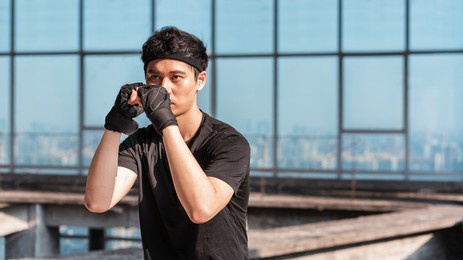 asian sports man is practicing boxing