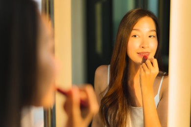 portrait beautiful young asian woman make up with cosmetic powder and lipstick on her face facial in bathroom interior