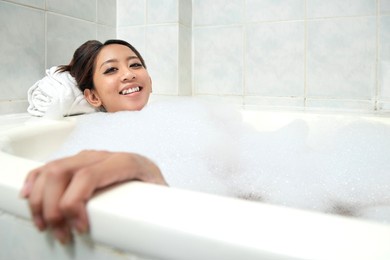 asian woman relaxing on the bathtub