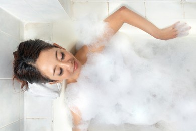 asian woman relaxing on the bathtub