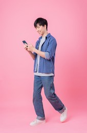 young asian man posing on pink background