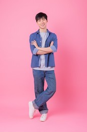 young asian man posing on pink background