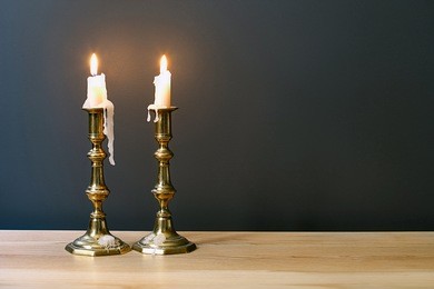 retro candelabra with burning candles in minimalist room interior 	 