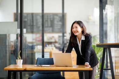 portrait of young asian woman hand freelancer is working her job on computer tablet in modern office. doing accounting analysis report real estate investment data, financial and tax systems concept.